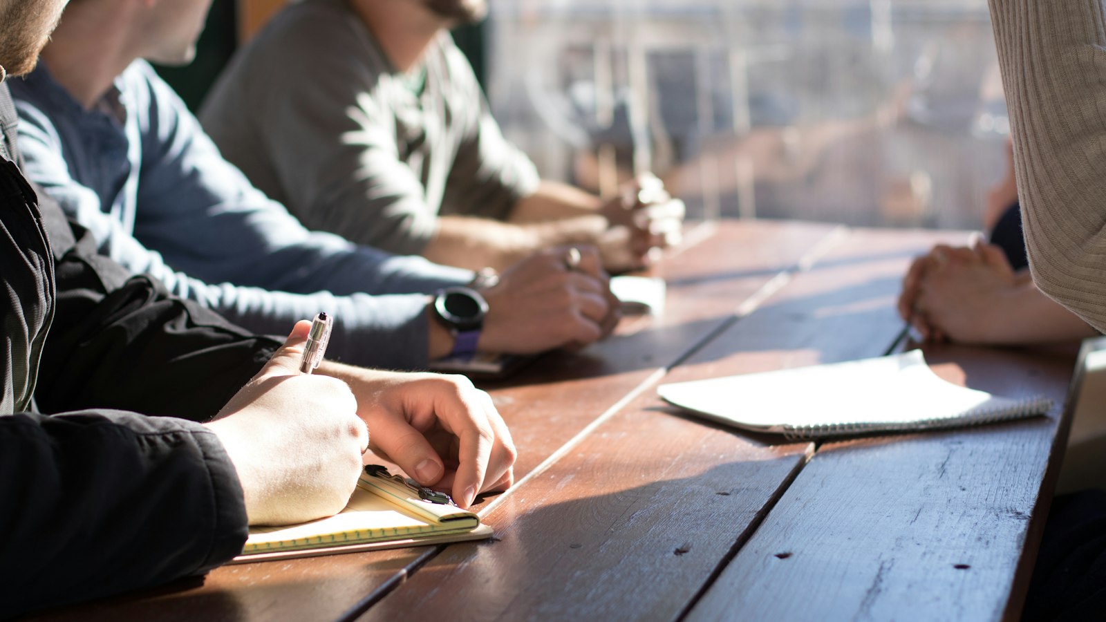 Sales team meeting around a table