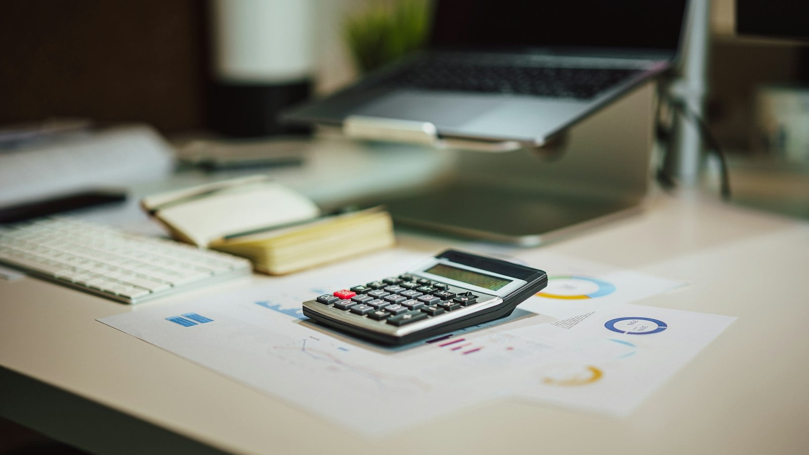 Calculator and reports on a desk